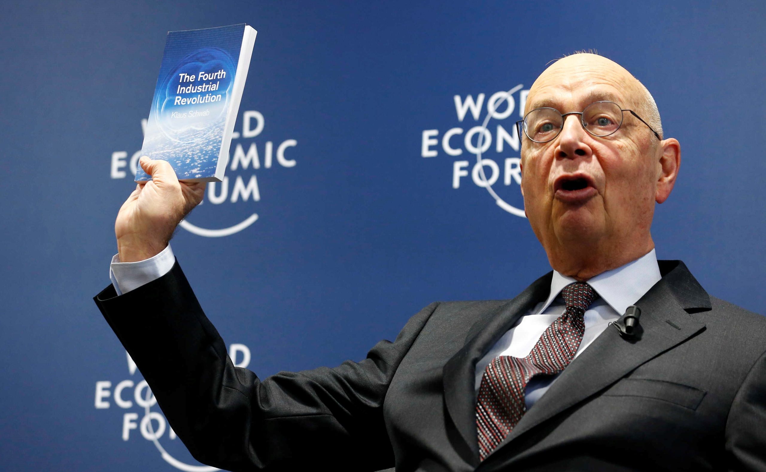 WEF Executive Chairman and founder Schwab presents his book, 'The Fourth Industrial Revolution', during a news conference in Cologny